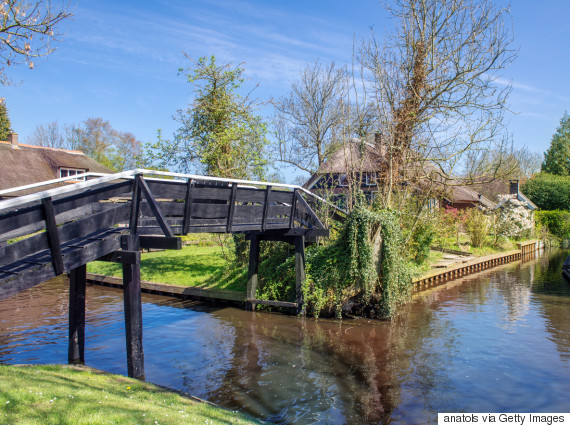 Bridge over canal in Giethoorn, a small village in the Netherlands. Part of the village has no car roads and some houses are accessible by boat only.