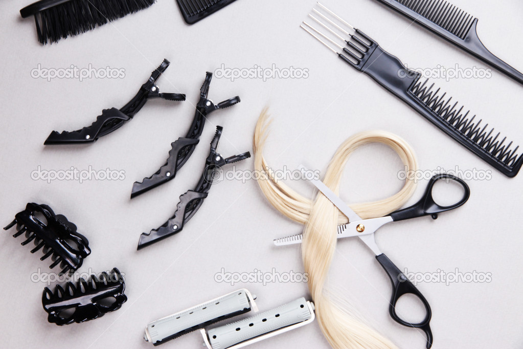 Professional hairdresser tools on gray background